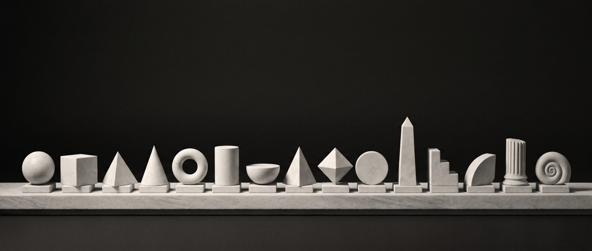 A neat horizontal row of fifteen carved pale stone geometric primitives aligned along a long stone shelf.